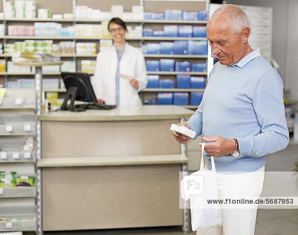 Man picking up prescription at pharmacy