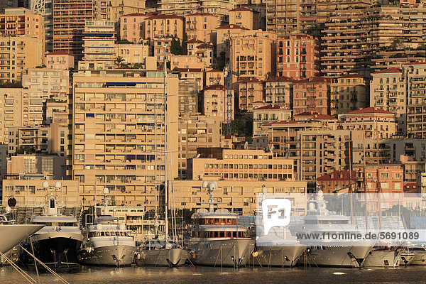 High-rise buildings in the district of La Condamine and cruisers in the early morning  Port Hercule  Principality of Monaco  French Riviera  Mediterranean Sea  Europe