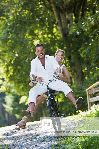 Austria  Salzburg County  Couple riding bicycle