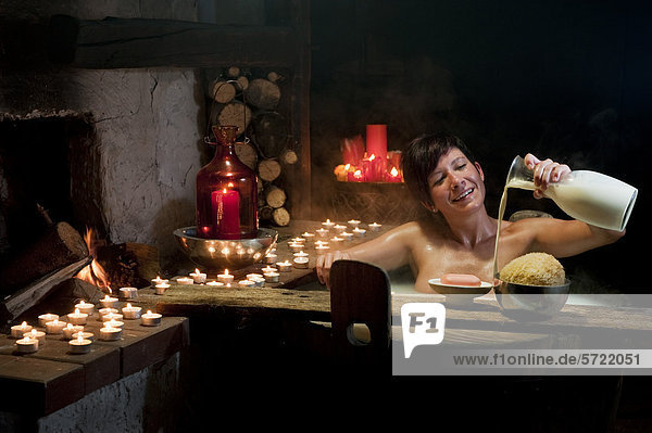 Austria  Salzburg County  Young woman taking bath in wooden tub