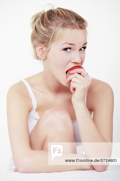 Young woman biting apple  portrait