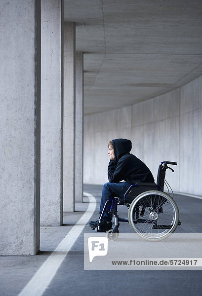 Austria  Mondsee  Young man sitting on wheelchair at subway