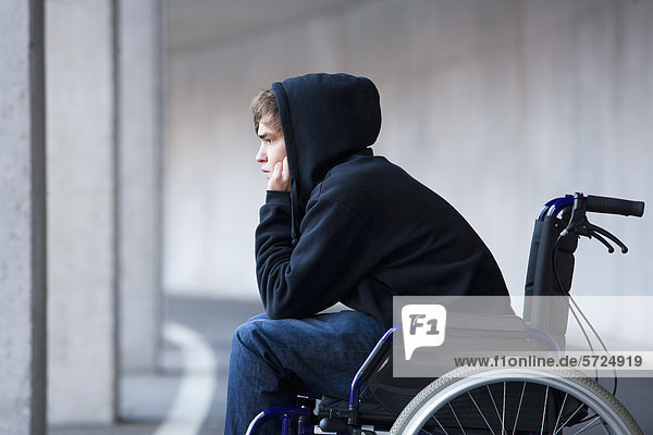 Austria  Mondsee  Young man sitting on wheelchair at subway