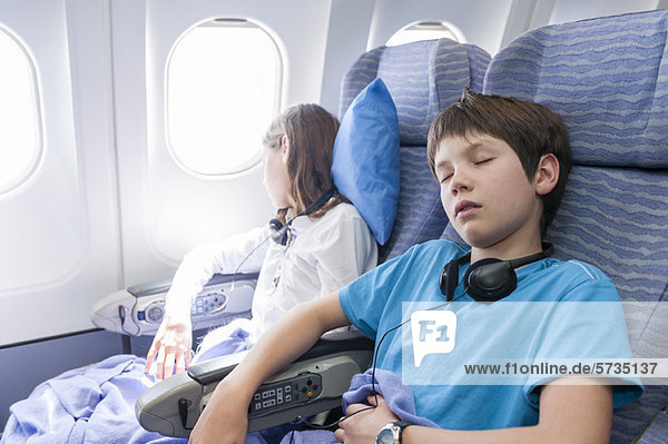 Kinder schlafen im Flugzeug