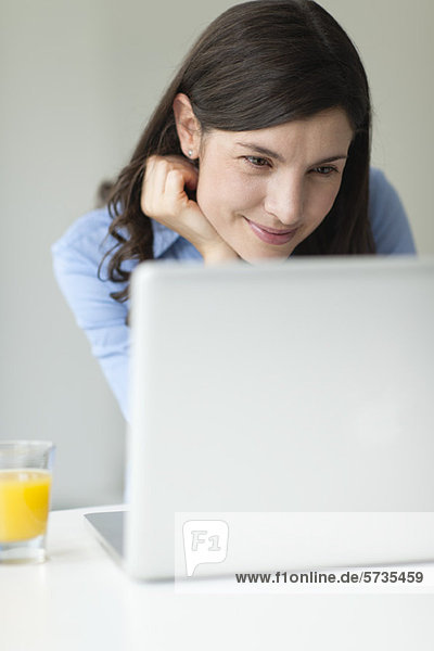 Mid-adult woman using laptop computer