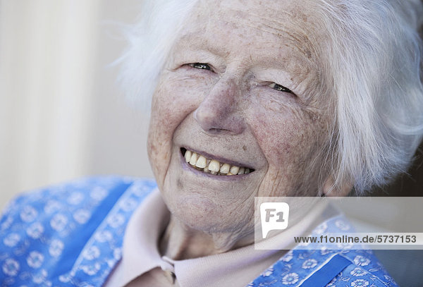 Smiling elderly woman with white hair  portrait