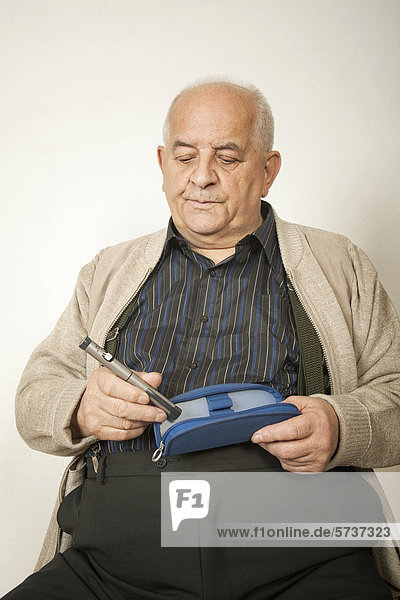 Overweight man with an insulin syringe
