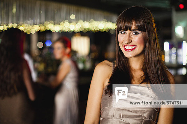 Smiling woman standing in bar
