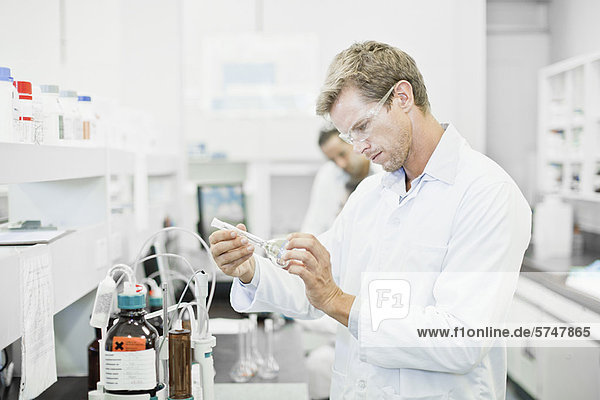 Scientist examining liquid in lab