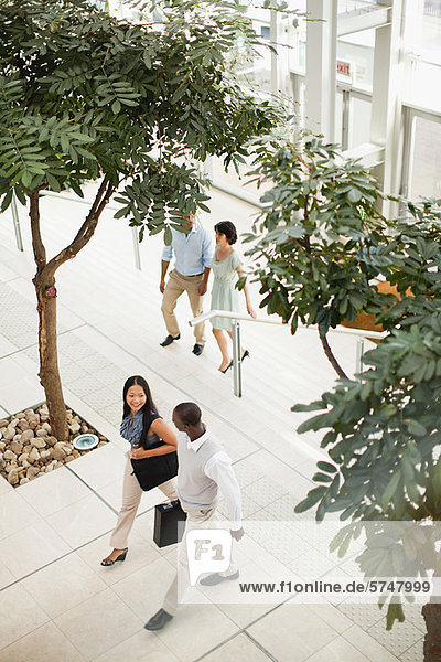 Business people walking in lobby