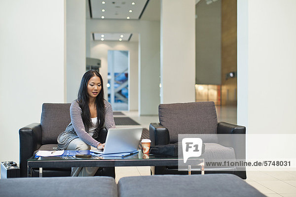 Businesswoman working in lobby