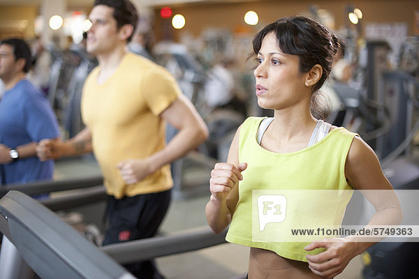 People using treadmills in gym