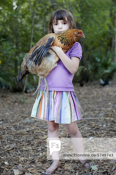 Girl holding hen