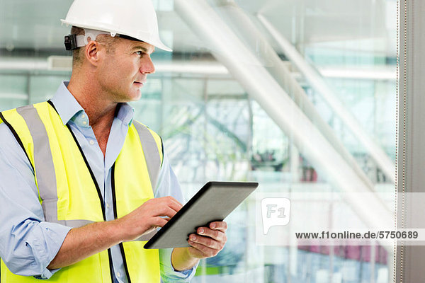 Engineer using digital tablet in office