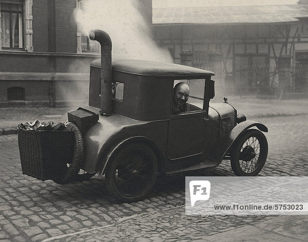 Historical picture of a car driven with coals
