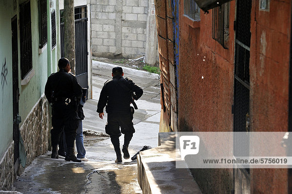 Heavily armed police units patrolling in the poor neighborhood of El Esfuerzo  the district is controlled by rivalling gangs of youths  Maras  El Esfuerzo  Zona 5  Guatemala City  Guatemala  Central America