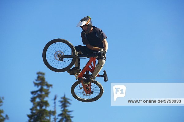 Mountainbiker zieht einen Sprung in Whistler Village Mountain Bike Park  British Colunbia  Kanada.