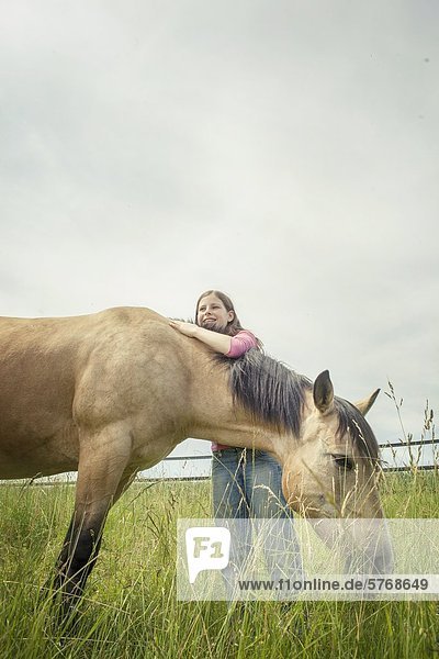 Girl and Paint Horse on meadow  Traishof  Koenigsbach-Stein  Baden-Wuerttemberg  Germany  Europe