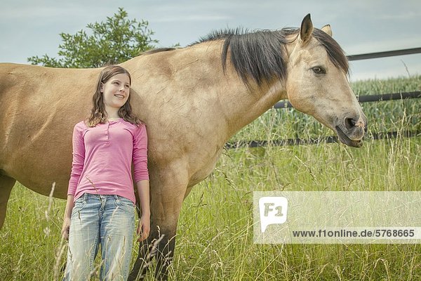 Girl and Paint Horse on meadow  Traishof  Koenigsbach-Stein  Baden-Wuerttemberg  Germany  Europe