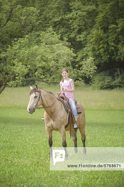Girl sitting on Paint Horse  Traishof  Koenigsbach-Stein  Baden-Wuerttemberg  Germany  Europe