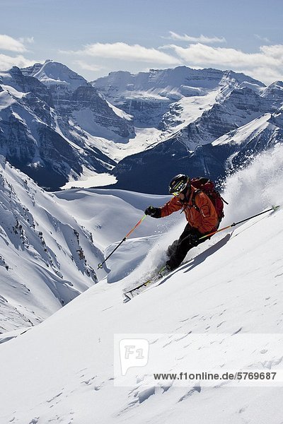 Young man skiing powder at Lake Louise Ski Area  Banff National Park  Alberta  Canada.