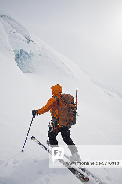 A man ski touring on a glacier while on a backcountry ski hut trip in the canadian rockies near Golden  British Columbia  Canada