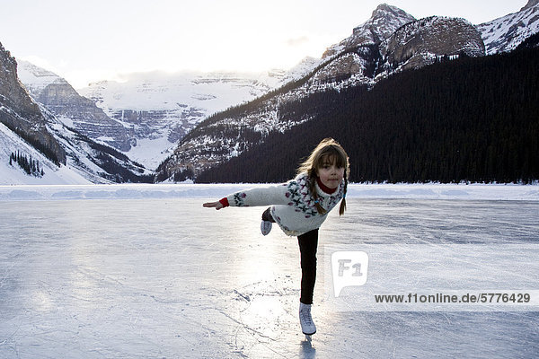 Young girl ice skating at Lake Louise  Banff National Park  Alberta  Canada.