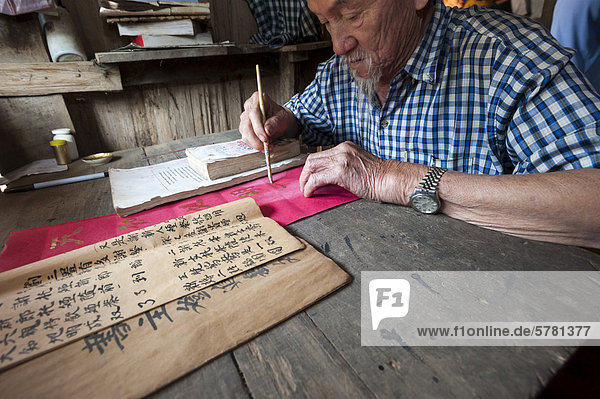 Älterer Chinese am Schreibtisch  ethnische Minderheit  alte chinesische Schreibkunst  Nordthailand  Thailand  Asien