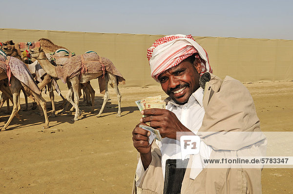 Camel driver with stakes  Al Sheehaniya  camel racing track  Doha  Qatar  United Arab Emirates  Middle East