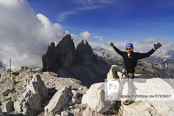 Teenager climbing on the Paternkofel fixed rope route  here standing on the summit of Paternkofel mountain  Tre Cime di Lavaredo peaks  Hochpustertal valley  Dolomites  Province of Bolzano-Bozen  Italy  Europe
