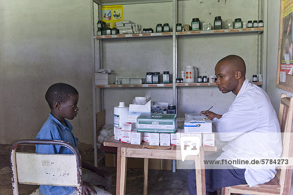 Boy receiving anti-retroviral medicines in an HIV-AIDS clinic from a pharmacist  Quelimane  Mozambique  Africa