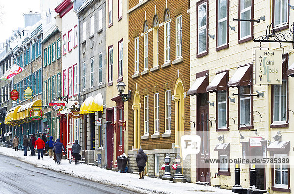 Tourists walking on an old street with Heritage commercial buildings in the Old Quebec in winter  Canada