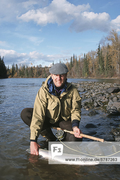 Angler with steelhead  Bulkley river  British Columbia  Canada.