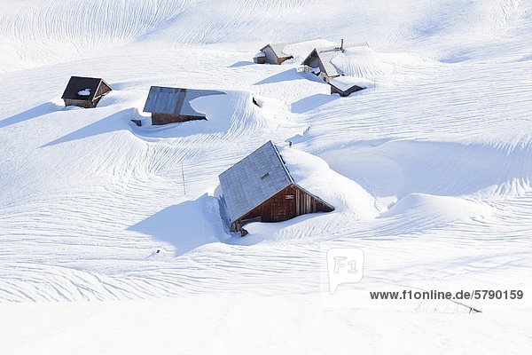 Snow-covered alpine huts at the Gosaukamm Austria