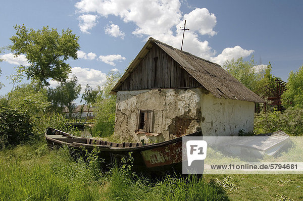Old boat in front of dilapidated house  in Vilkovo or Vylkove  Ukraine  Eastern Europe