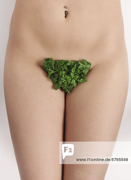 Naked woman  has parsley as pubic hair
