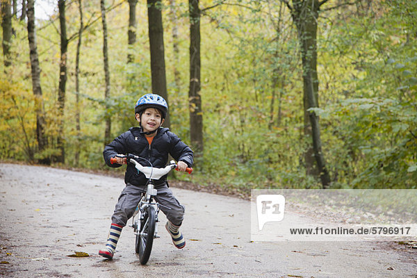 Boy riding bike  smiling at camera
