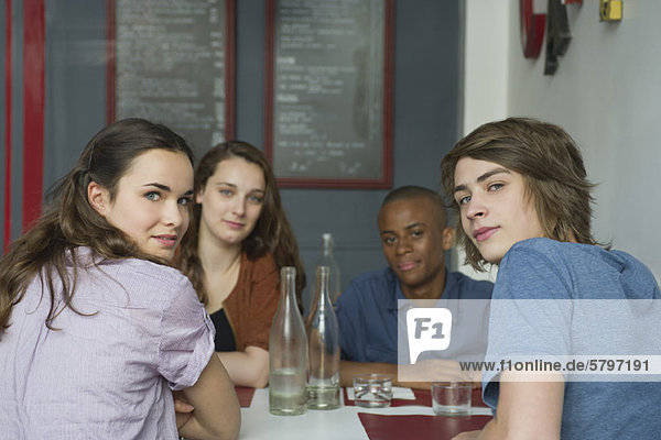 Young adult friends hanging out in cafe