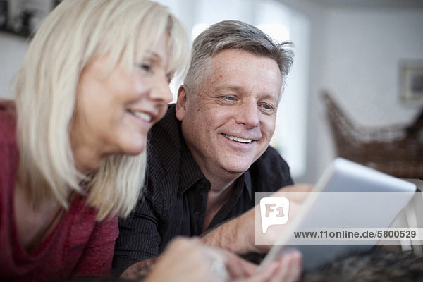 Glückliches Paar mit digitalem Tablett