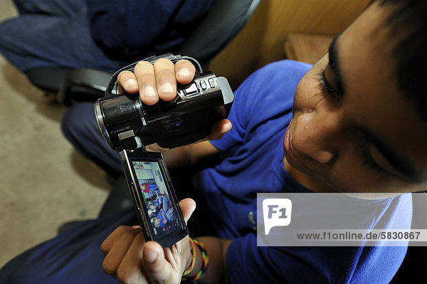 'Video course for young people  participant is holding a video camera in his hands for the very first time  organisation ''El Culebron Timbal''  Cuartel V  Moreno  Buenos Aires  Argentina  South America'