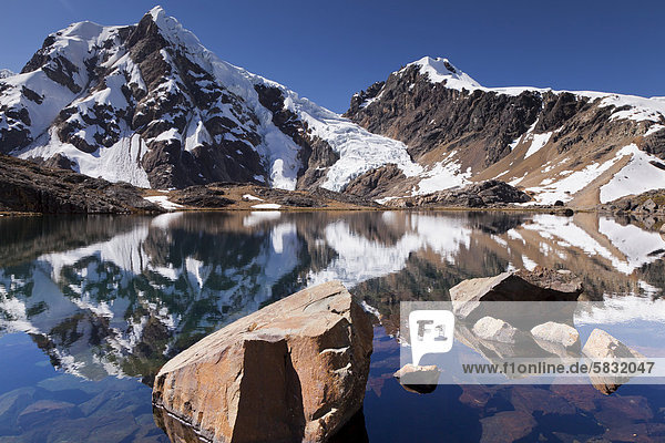 Peaks of the Cordillera Huayhuash mountain range being reflected in a mountain lake  Cordillera Huayhuash mountain range  Andes  Peru  South America