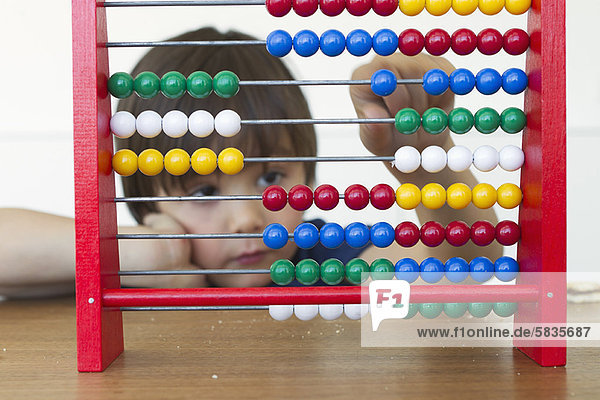 Boy playing with abacus