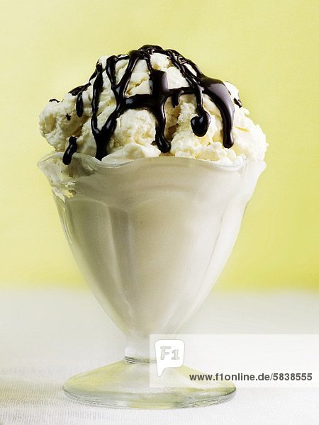 Vanilla Ice Cream in Dessert Dish Topped with Chocolate Sauce