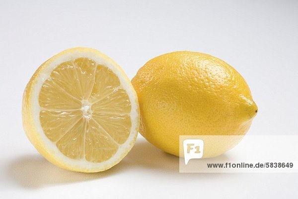 Half and Whole Lemon on White Background