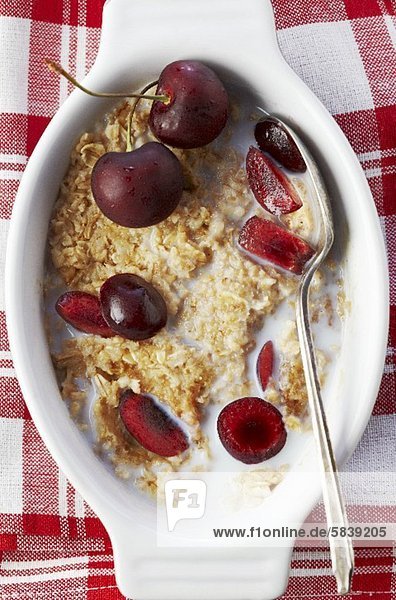 'Bowl of Steel Cut Oats with Milk and Cherries