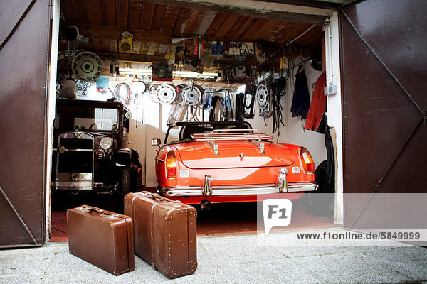 Vintage car and trunk suitcases in garage