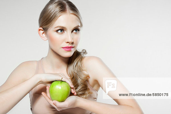 Junge Frau mit Apfel in der Hand
