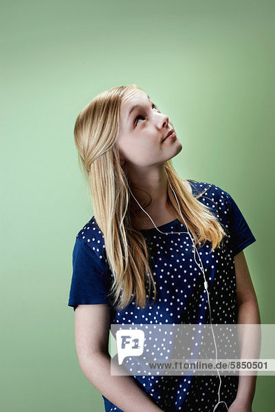 Teenage girl listening to mp3 player