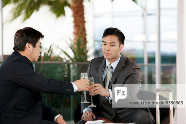 Businessmen toasting with wine