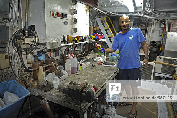 Workbench and the machinist in the engine room of a ship  Okeanoss Aggressor  Costa Rica  Central America